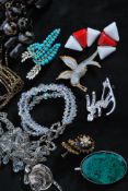 An assortment of vintage costume jewellery, beads and fittings. To include a large enamelled