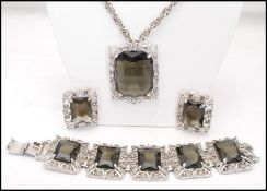 A 1960s signed vintage Sarah Coventry, Celebrity, 1962, silver-tone smokey quartz glass demi