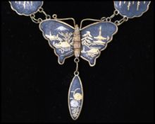 A 1950's damascene butterfly pendant drop necklace having twin strand chains with clip clasp.
