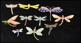 A collection of vintage dragonfly bug brooch pins to including rhinestone set, faux pearl, enamel,