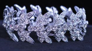 A 1960s signed Sarah Coventry Worlds Fair, 1964, bracelet being set with rhinestones with clip clasp