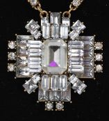 A vintage rhinestone set gold-tone necklace with large 3D cross pendant set with baguette and