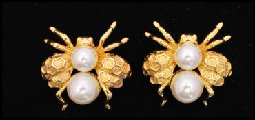 A vintage pair of signed Napier gold-tone bee bug brooches set with faux pearl with hexagonal design