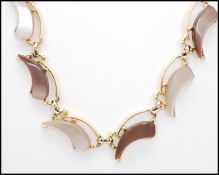 A 1950's silver-tone black and pearl grey lucite necklace together with a similar brown and beige