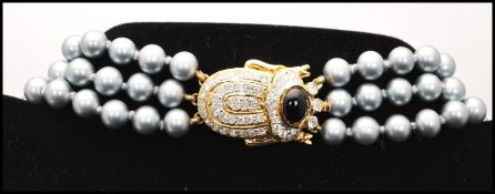 A vintage signed Vogue Bijoux Italy faux pearl necklace having large rhinestone encrusted pendant