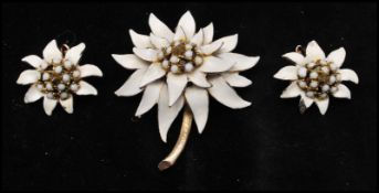 A signed gold tone enamel flower brooch and earring set. Signed HAR. Brooch measures 5.5cms.