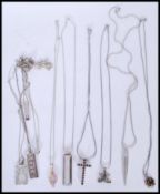 A selection of silver necklaces to include a cruci