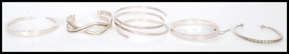 A selection of silver bangles, one having a hinged