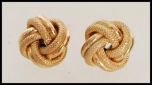 A pair of vintage knot design yellow metal earring