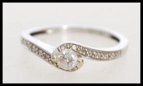 A hallmarked 18ct white gold and diamond ring havi