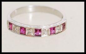 A stamped 18k white gold ring with channel inset a