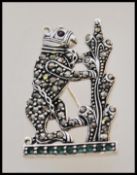 A stamped sterling silver brooch in the form of a
