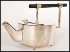A silver plated tea pot in the Christopher Dresser