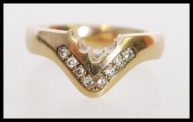 A hallmarked 9ct gold and diamond wishbone ring.