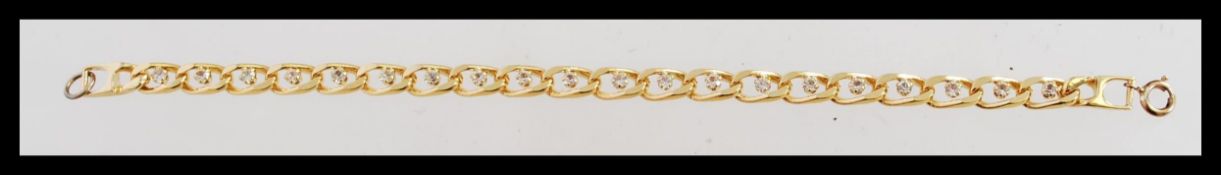 A gold plated flat linked bracelet with a spring r