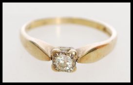 A 9ct gold hallmarked solitaire ring with inset di