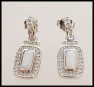 A pair of stamped 925 silver earrings with a squar