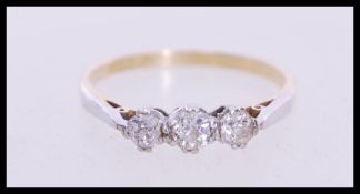 A stamped 18ct gold and platinum three stone ring