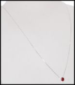 A hallmarked 18ct white gold pendant necklace with