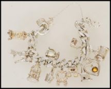 A 20th century silver hallmarked charm bracelet, w