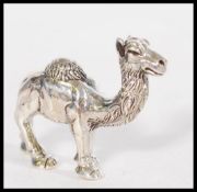A stamped sterling silver figurine of a camel. Wei