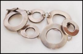 A collection of silver bracelets to include a hear