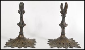 A pair of 19th century bronze scroll holders raise