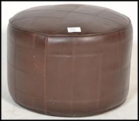 A vintage retro 20th century brown vinyl pouffe of
