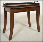 An early 20th century Edwardian mahogany tray on s