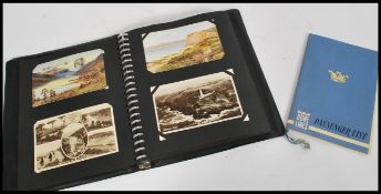 A vintage 20th century postcard album containing v