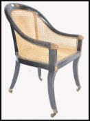 REGENCY EBONISED GILT PARCEL WOOD BERGERE CANED LIBRARY ARMCHAIR