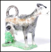 EARLY 19TH CENTURY STAFFORDSHIRE PEARLWARE COW CREAMER