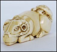 19TH CENTURY JAPANESE MEIJI PERIOD CARVED IVORY NETSUKE - SEATED OX