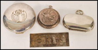 A collection of white metal items to include a silver plated sovereign holder, compacts and a