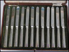 Am early 20th century cased set of twelve silver hallmarked knives by Elkington being hallmarked for