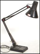 A 20th century retro black anglepoise desk lamp in black colourway having squared weighted base with