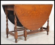 A 1920's solid country oak barleytwist gateleg / drop leaf dining table. Raised on barley twist legs