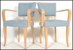 A pair of original French Art Deco style bridge chairs / armchairs. Raised on sabre tapered supports