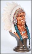 A vintage porcelain head bust of a Native American Red Indian Chief with detailed features raised on