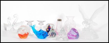 A collection of decorative and studio glass paperweights, to include Caithness, glass eagle,