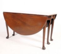A 19th century solid mahogany drop leaf / gate leg dining table having six legs opening to reveal