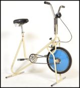 A vintage mid 20th Century  tubular frame exercise bike, low millage speedometer, tension adjustable