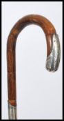 A silver hallmarked collared and mounted walking cane, London assay marks, curved crook handle