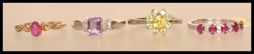 A selection of silver rings to include a stamped 925 flower head ring set with yellow and green