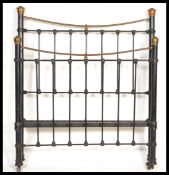 A 19th Century Victorian cast iron three quarter sized double bed frame with brass finials and