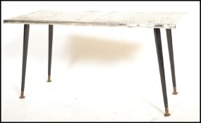 A mid century retro coffee - occasional table being raised on black dansette tapering legs with a