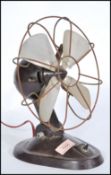 A vintage mid 20th Century bakelite desk fan by Braun,  on shaped stem and circular base. With