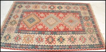 A vintage early 20th century decorative Kilim Persian / Islamic floor carpet rug having a muted
