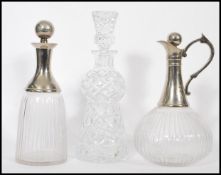 A pair of mid 20th century silver plate and cut glass decanters to include one bulbous form claret