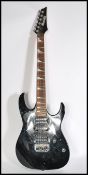 An Ibanez Gio Series six string electric guitar with black body serial number J031253885. Measures